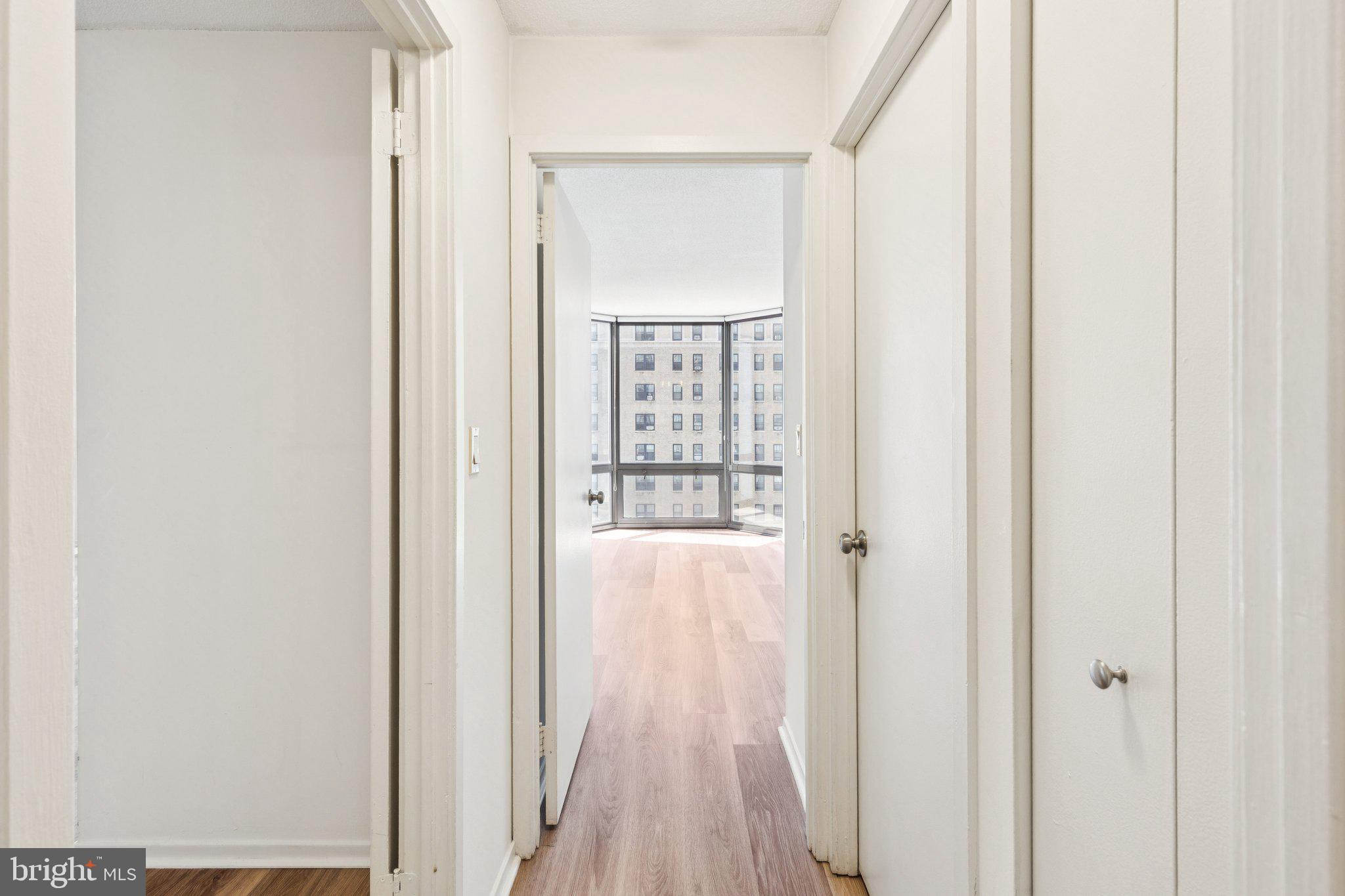 2020 Walnut Street, Unit 14J Philadelphia, PA 19103 - Photo 7 of 25 a view of a hallway with wooden floor and a bathroom