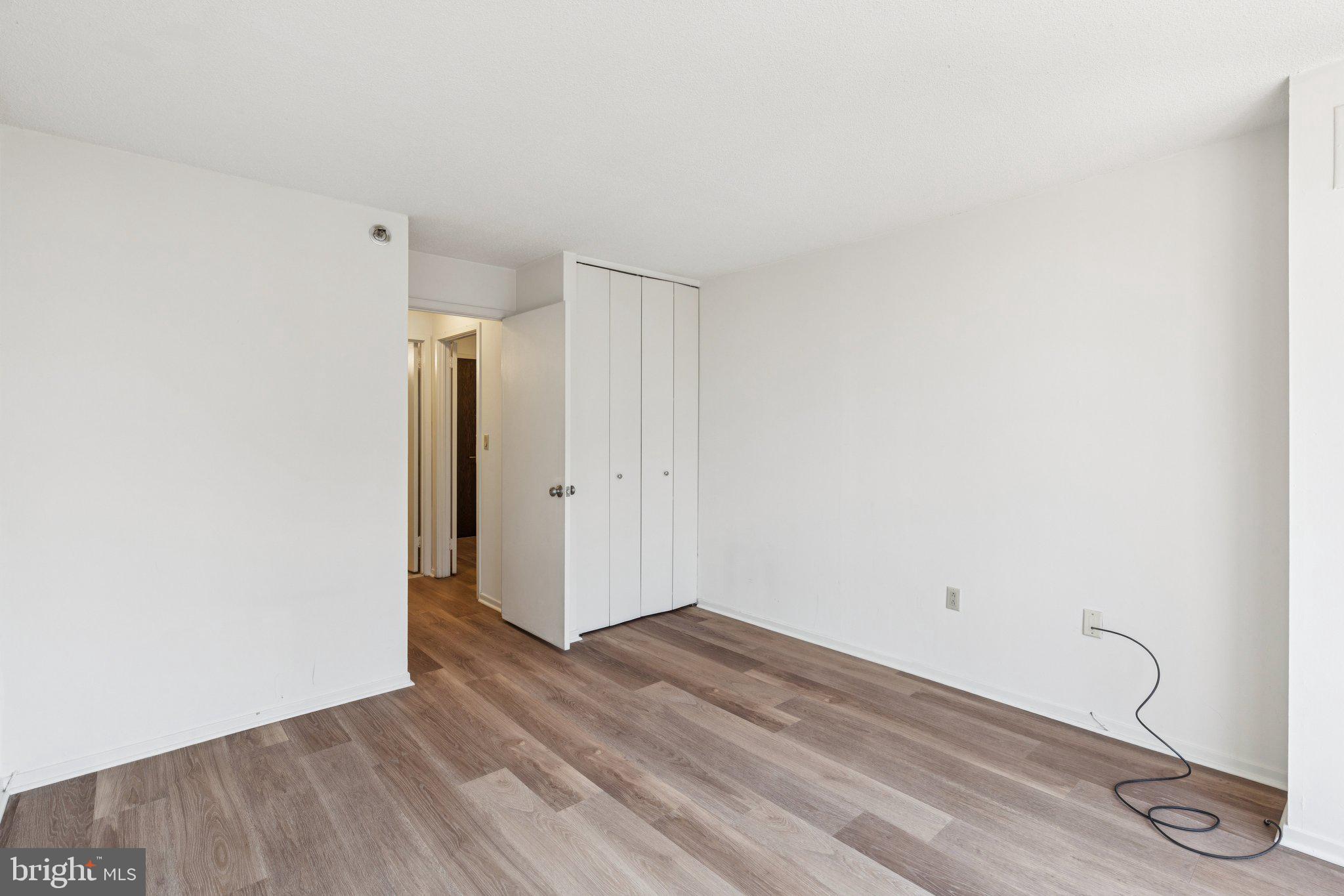 2020 Walnut Street, Unit 14J Philadelphia, PA 19103 - Photo 9 of 25 a view of room with walk in closet and wooden floor