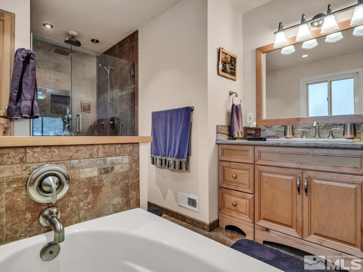 835 Russell Way Gardnerville, NV 89460 - Photo 11 of 40 a bathroom with a sink double vanity and a mirror