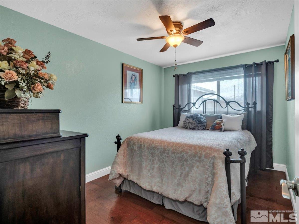 835 Russell Way Gardnerville, NV 89460 - Photo 12 of 40 a bedroom with a bed and a chandelier