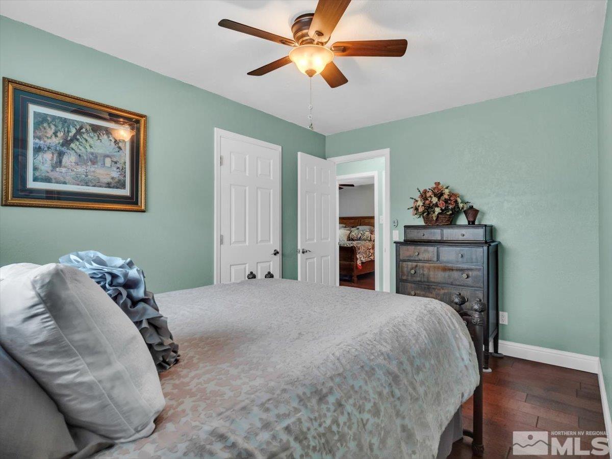 835 Russell Way Gardnerville, NV 89460 - Photo 13 of 40 a bedroom with a bed and a chandelier