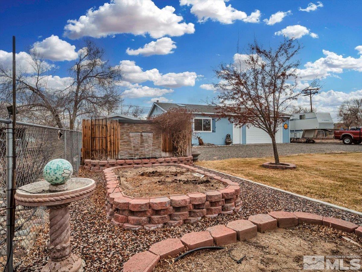 835 Russell Way Gardnerville, NV 89460 - Photo 23 of 40 a view of a backyard with large trees