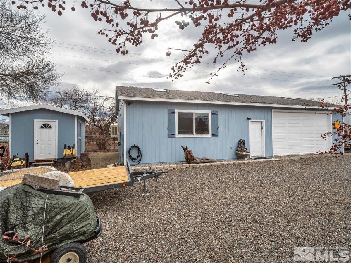 835 Russell Way Gardnerville, NV 89460 - Photo 25 of 40 a backyard of a house with barbeque oven and trees