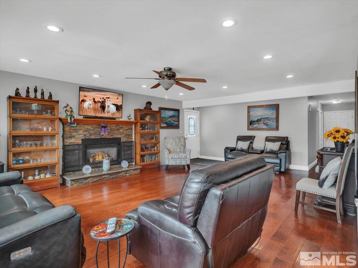 835 Russell Way Gardnerville, NV 89460 - Photo 5 of 40 a living room with furniture a fireplace and a flat screen tv