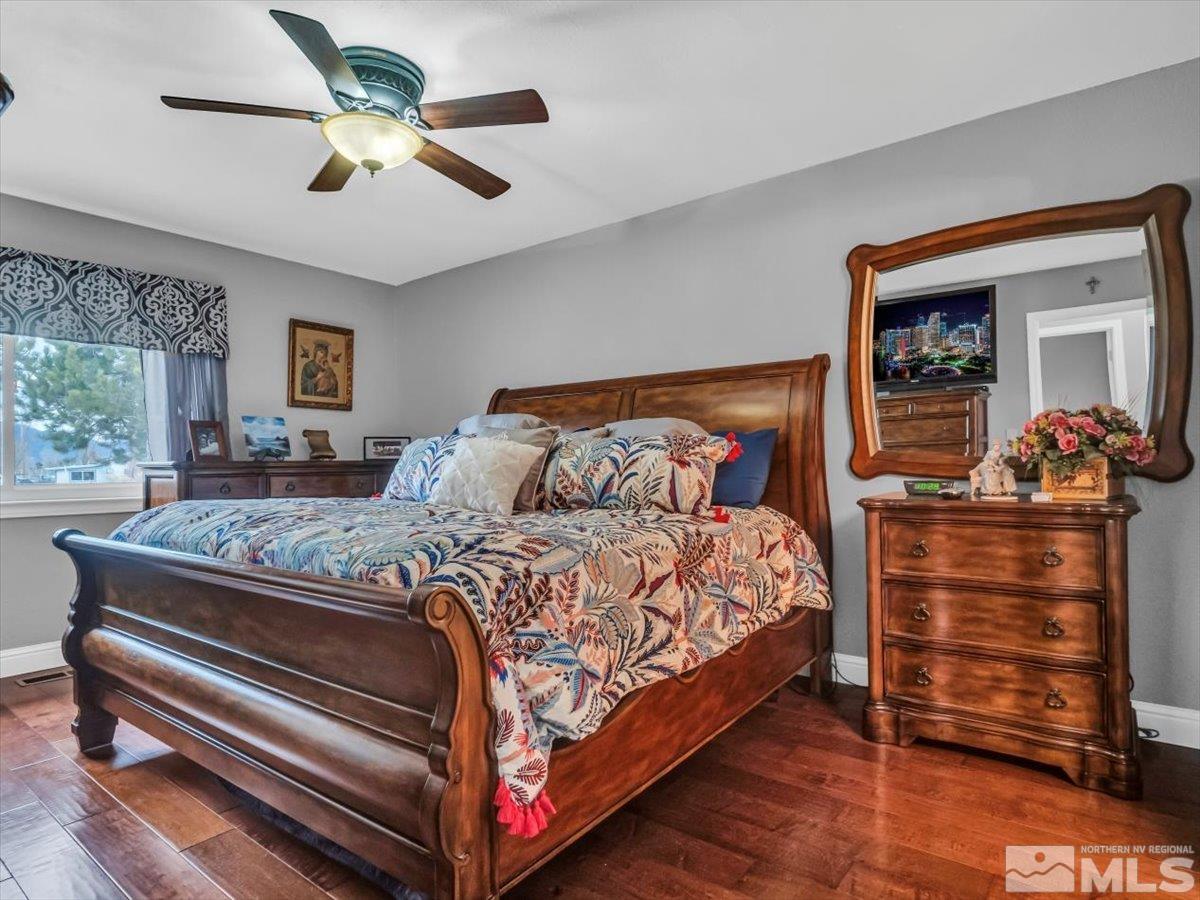 835 Russell Way Gardnerville, NV 89460 - Photo 8 of 40 a bedroom with a bed and a chandelier