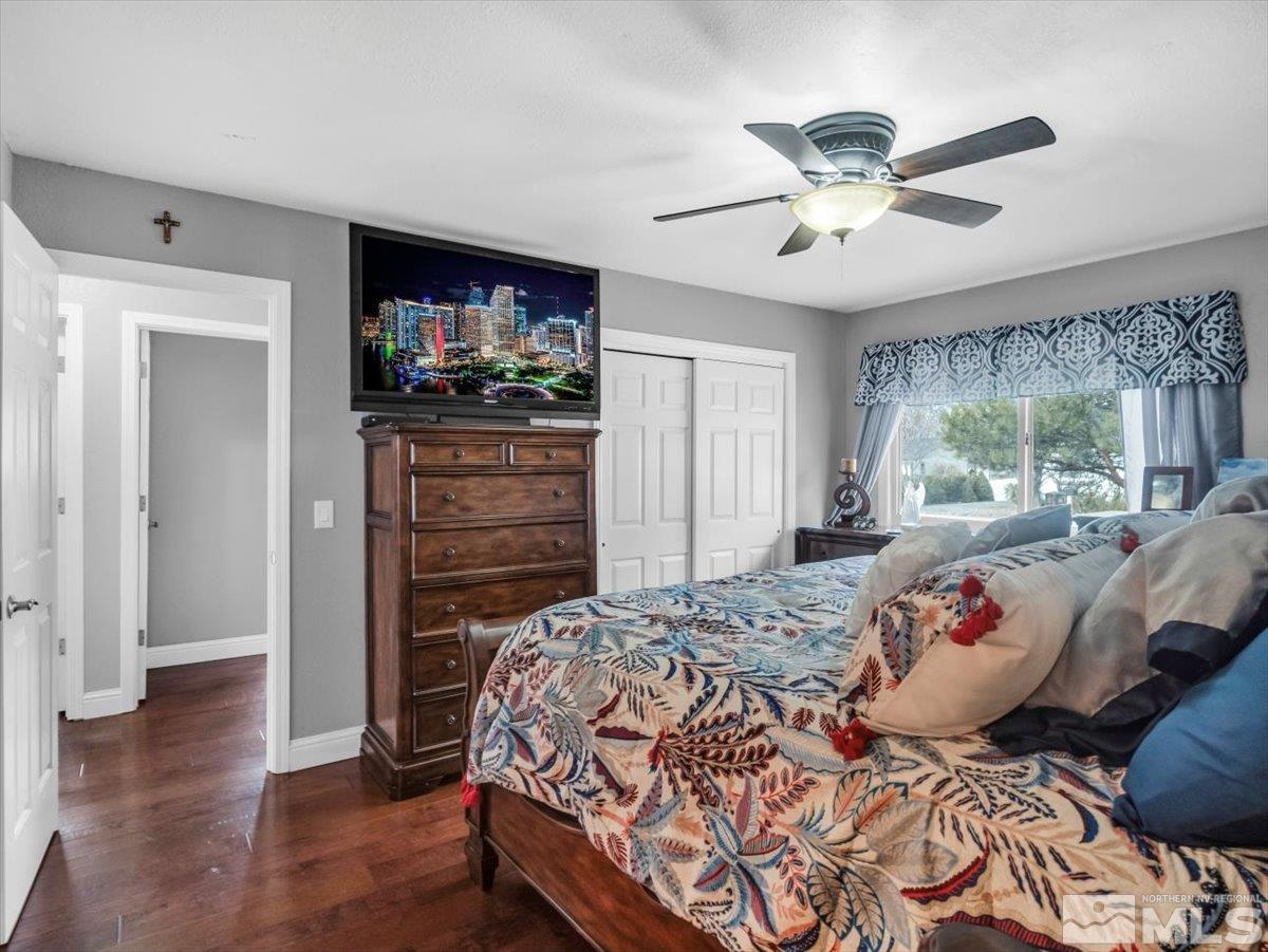 835 Russell Way Gardnerville, NV 89460 - Photo 9 of 40 a bedroom with a bed and a flat screen tv