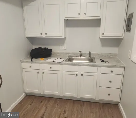 a kitchen with white cabinets and white appliances