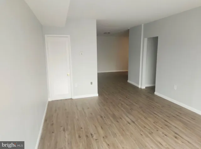 wooden floor in a hall with an empty room