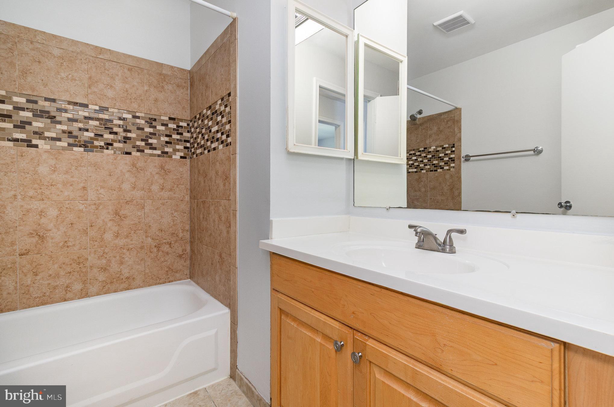 14888 Enterprise Lane Woodbridge, VA 22191 - Photo 13 of 25 a bathroom with a bathtub and a sink