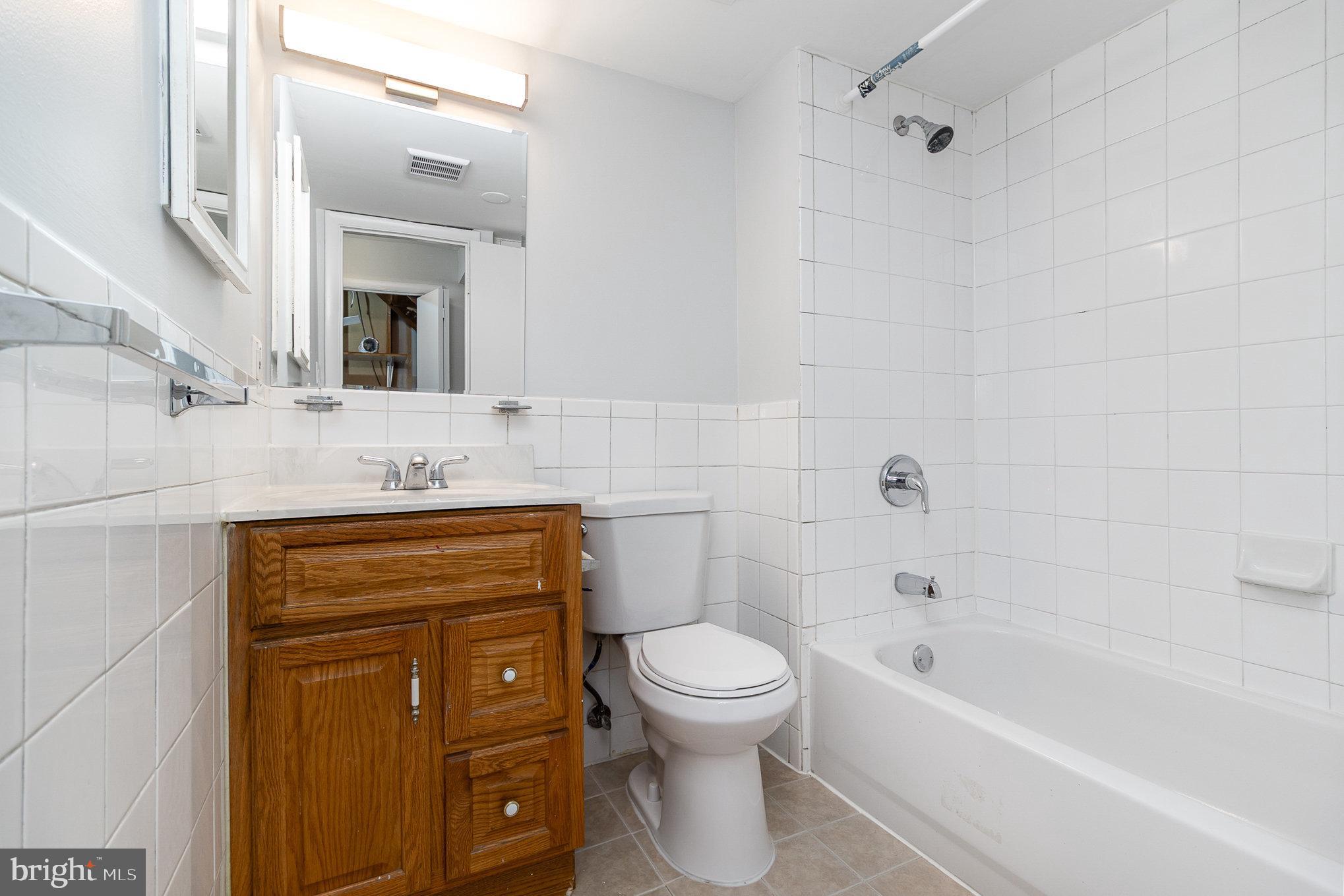 14888 Enterprise Lane Woodbridge, VA 22191 - Photo 17 of 25 a bathroom with a sink toilet and shower
