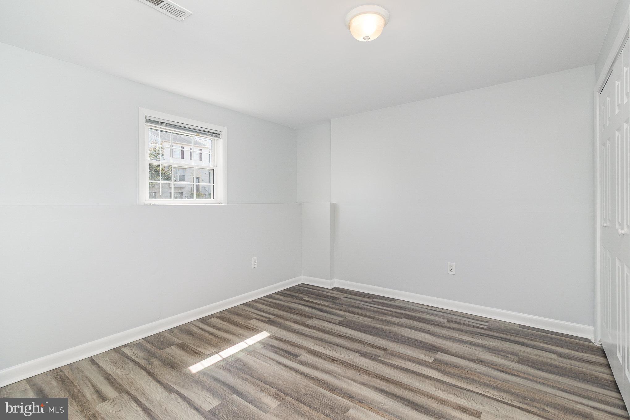 14888 Enterprise Lane Woodbridge, VA 22191 - Photo 19 of 25 a view of a room with wooden floor and closet