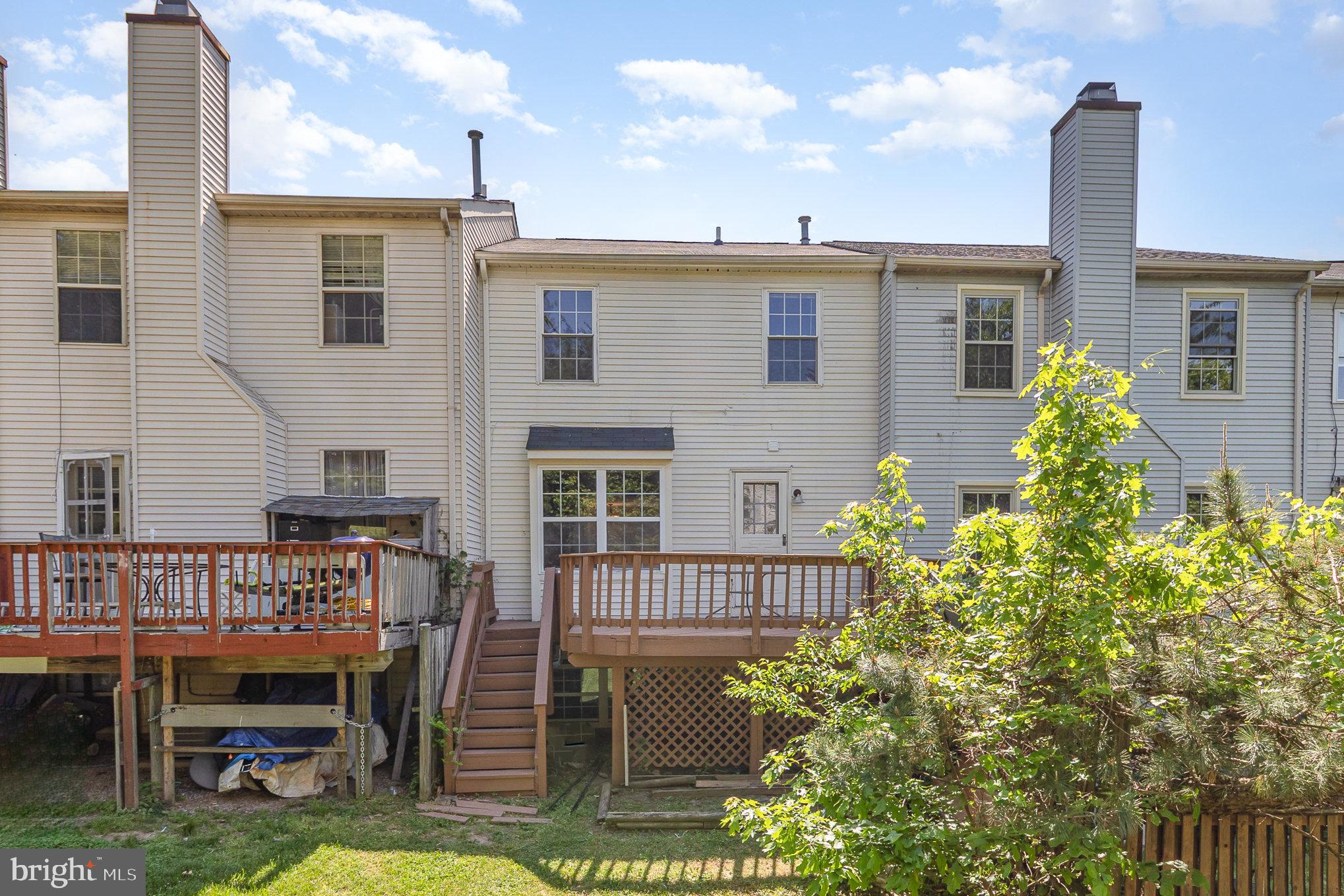 14888 Enterprise Lane Woodbridge, VA 22191 - Photo 20 of 25 a front view of a house with garden