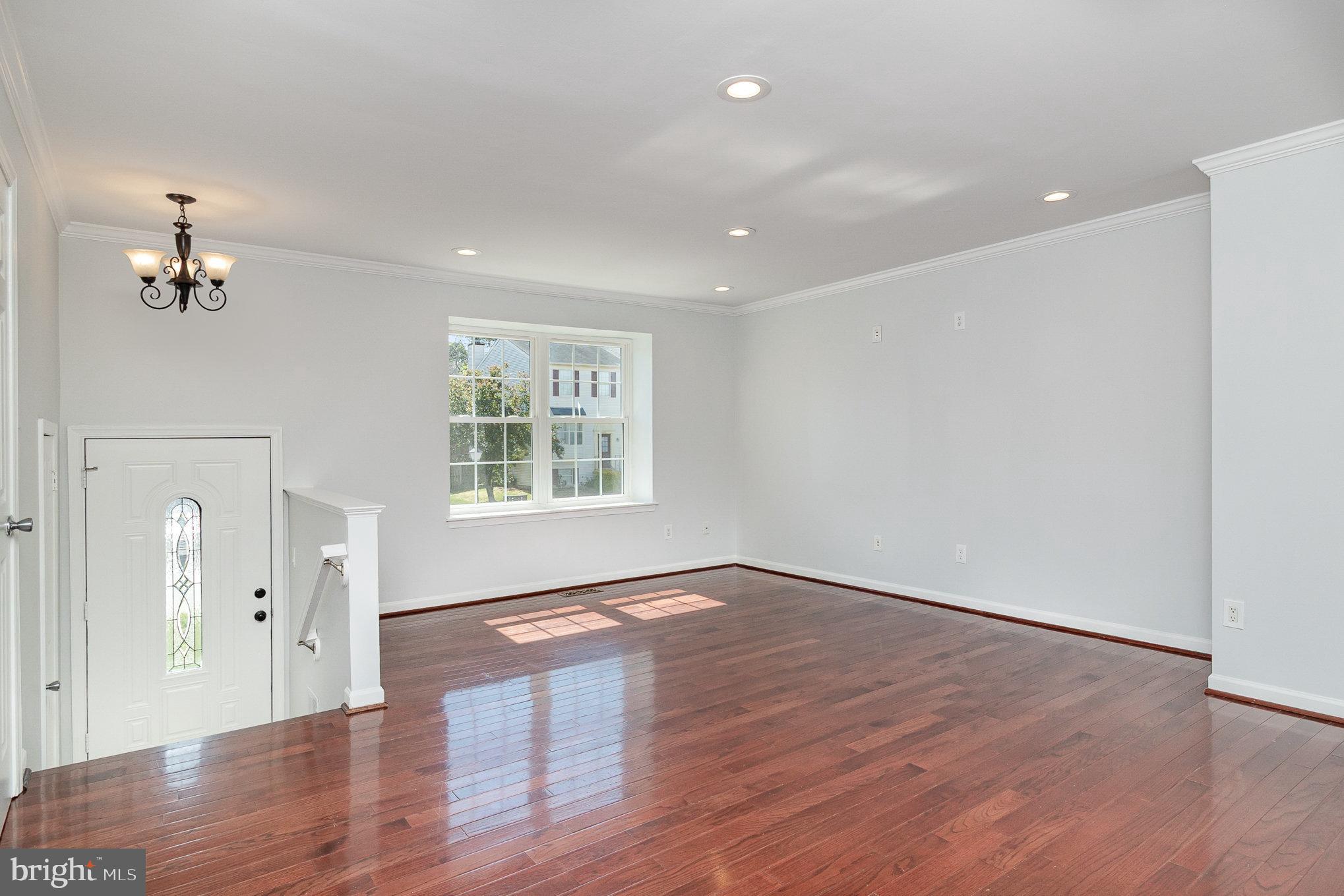 14888 Enterprise Lane Woodbridge, VA 22191 - Photo 4 of 25 wooden floor in an empty room with a window