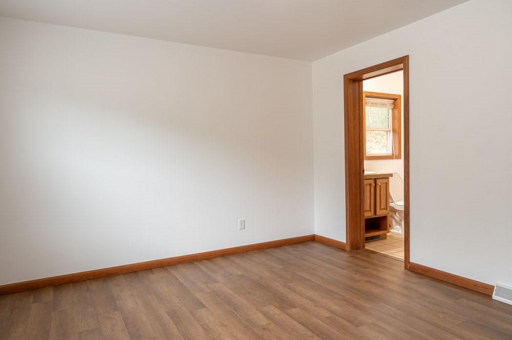 116 Autumn Street Aliquippa, PA 15001 - Photo 13 of 26 an empty room with wooden floor and window