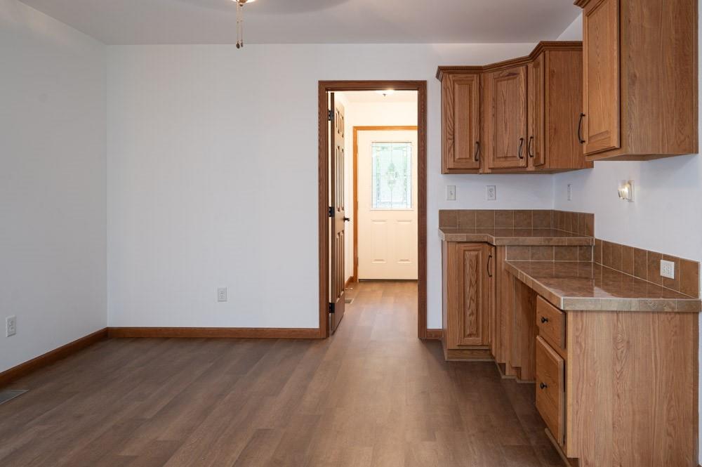 116 Autumn Street Aliquippa, PA 15001 - Photo 15 of 26 an empty room with wooden floor and cabinets