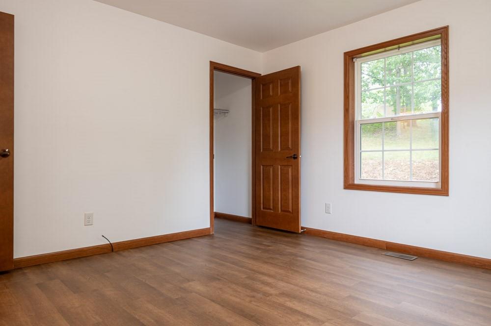 116 Autumn Street Aliquippa, PA 15001 - Photo 19 of 26 an empty room with wooden floor and windows