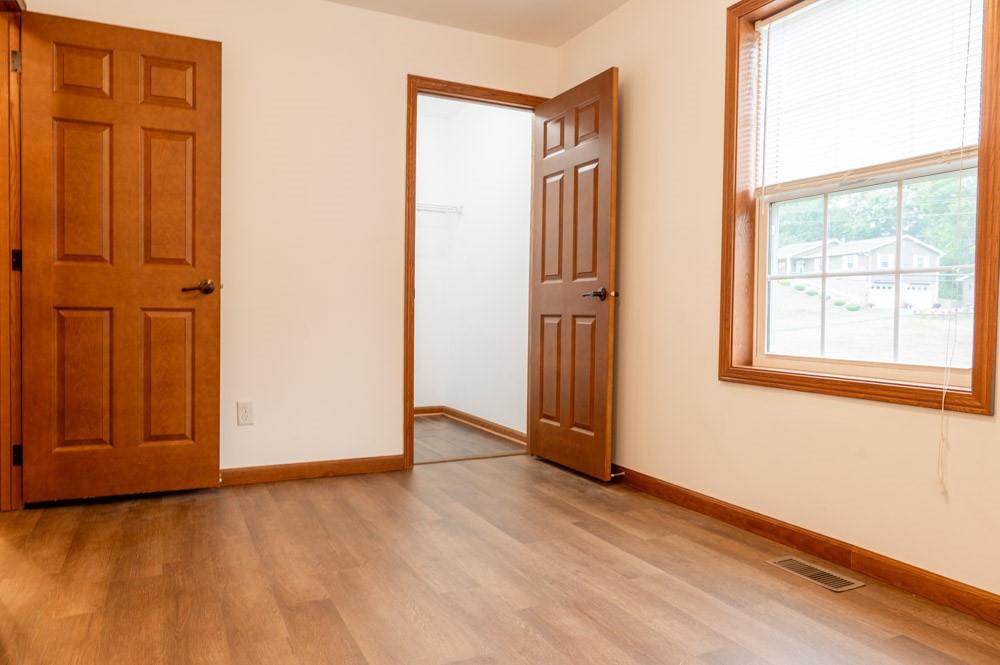 116 Autumn Street Aliquippa, PA 15001 - Photo 20 of 26 an empty room with wooden floor and windows