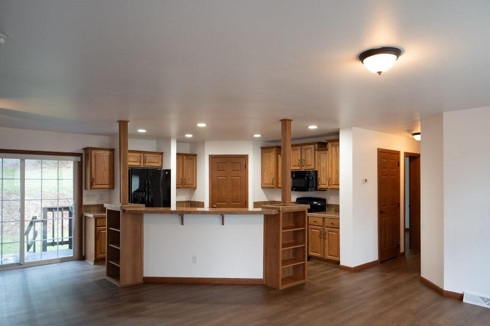 116 Autumn Street Aliquippa, PA 15001 - Photo 4 of 26 a kitchen with stainless steel appliances kitchen island granite countertop a refrigerator oven a sink and white cabinets with wooden floor