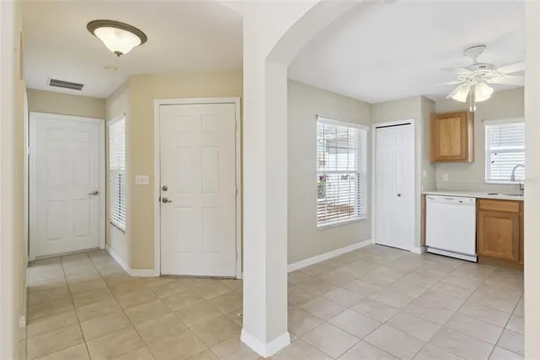 a kitchen with a refrigerator sink and cabinets