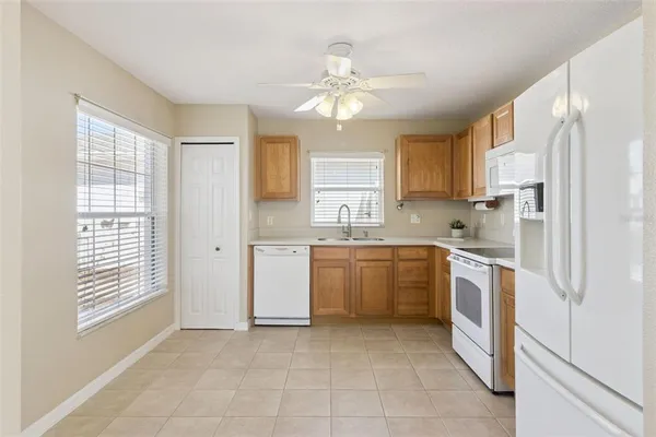 a kitchen with cabinets appliances and sink