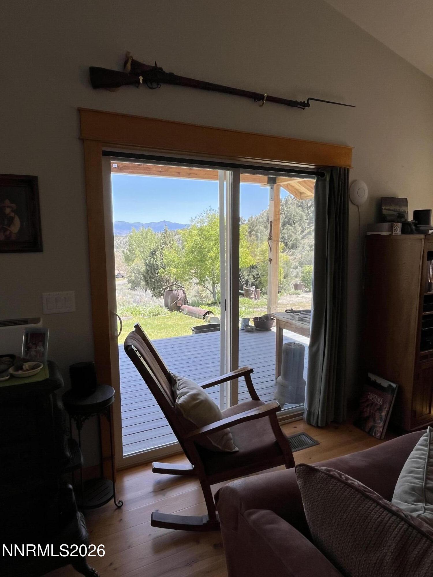 15 Wine Glass Way Kingston, NV 89310 - Photo 11 of 59 a living room with furniture a floor to ceiling window and a flat screen tv