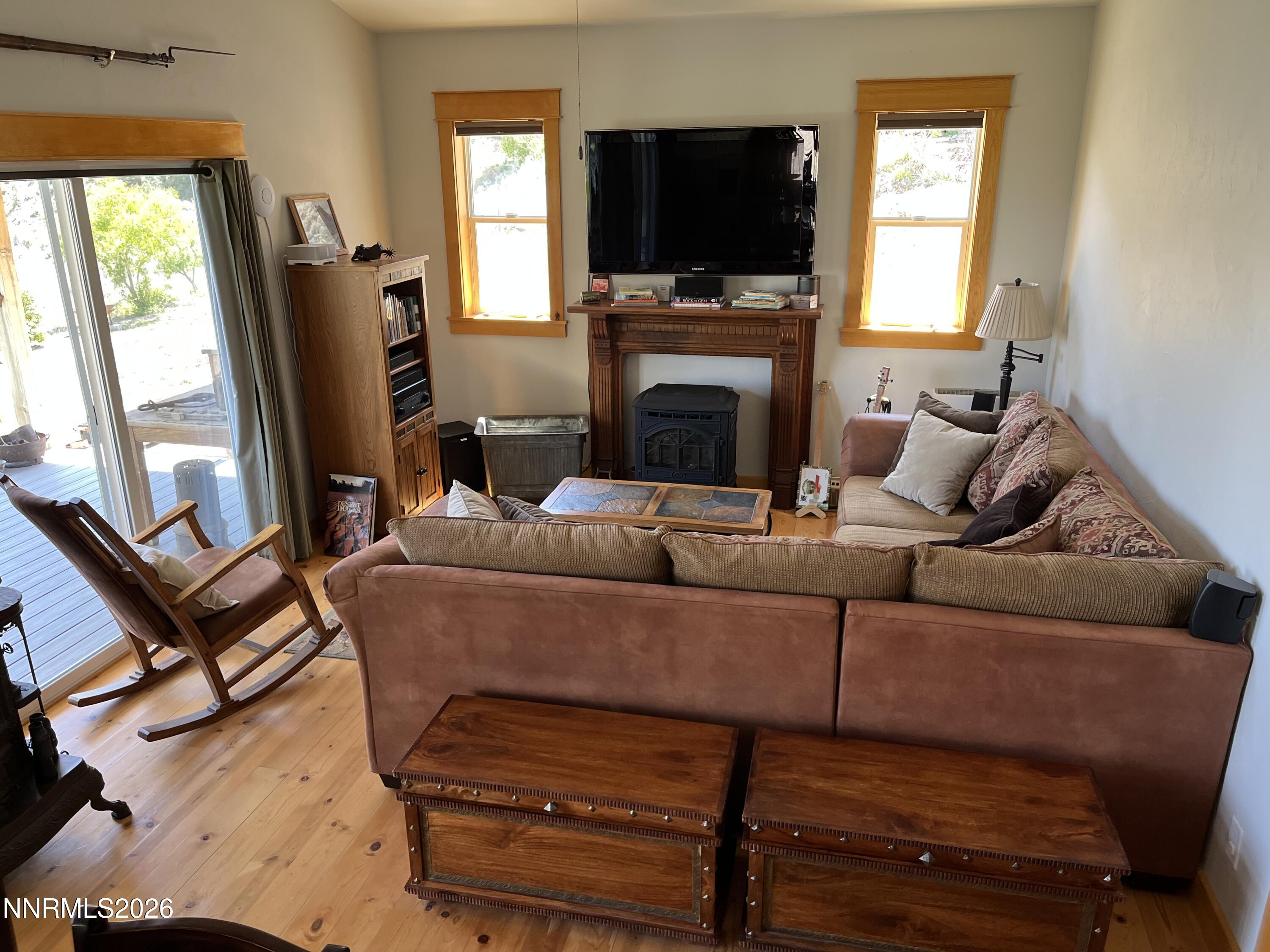 15 Wine Glass Way Kingston, NV 89310 - Photo 12 of 59 a living room with furniture a flat screen tv and a fireplace