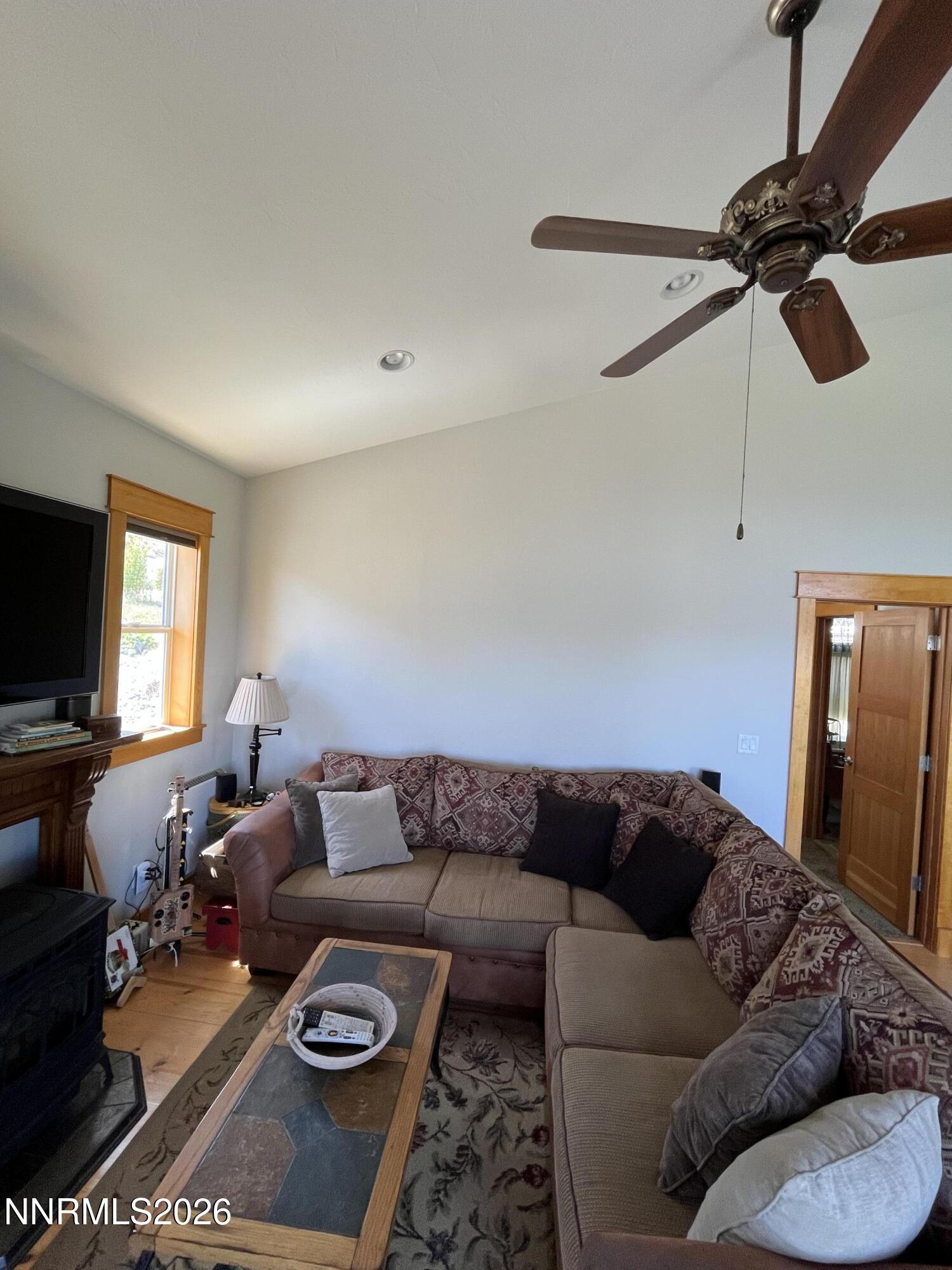 15 Wine Glass Way Kingston, NV 89310 - Photo 15 of 59 a living room with furniture a rug and a flat screen tv