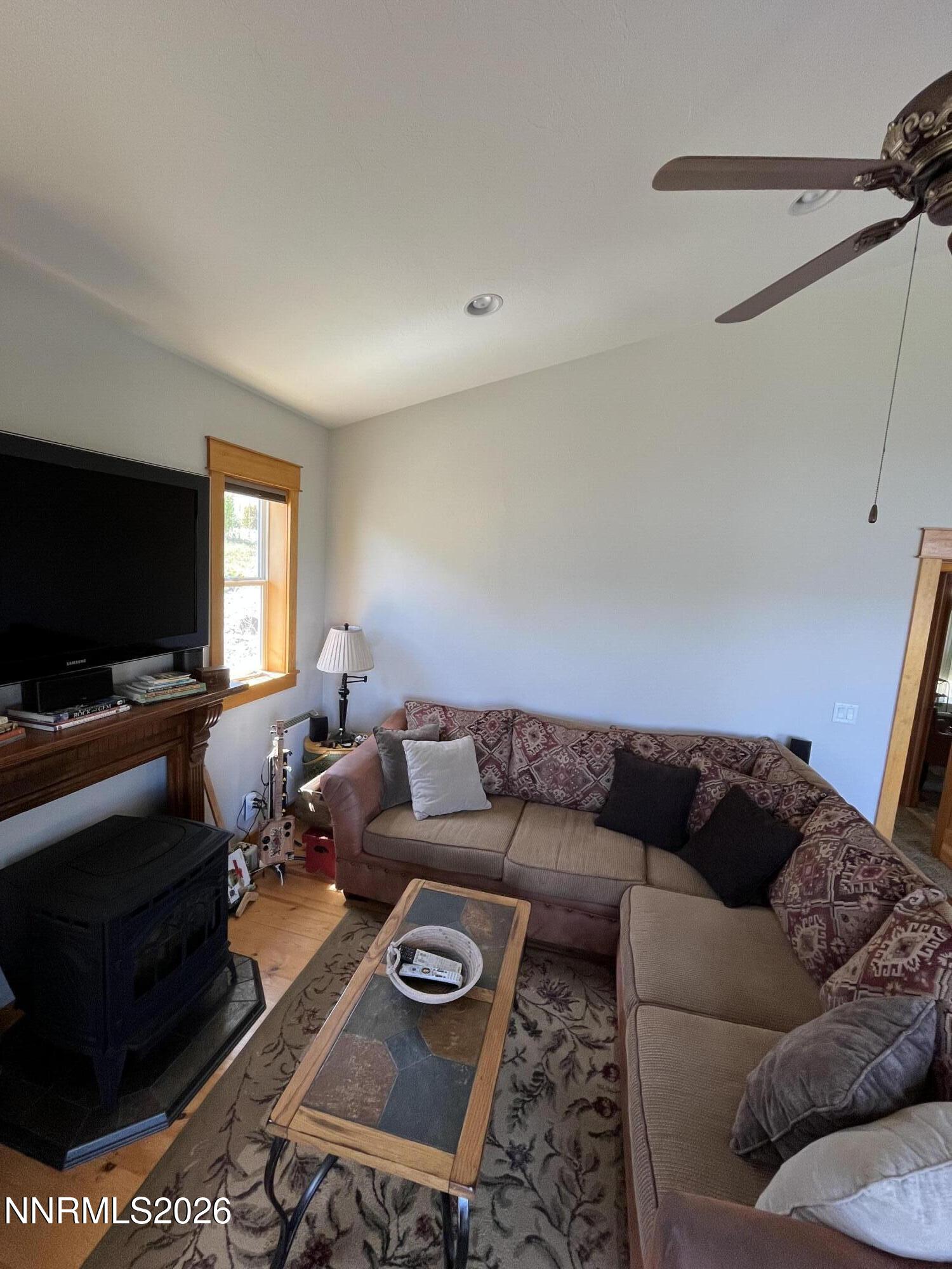 15 Wine Glass Way Kingston, NV 89310 - Photo 16 of 59 a living room with furniture and a flat screen tv