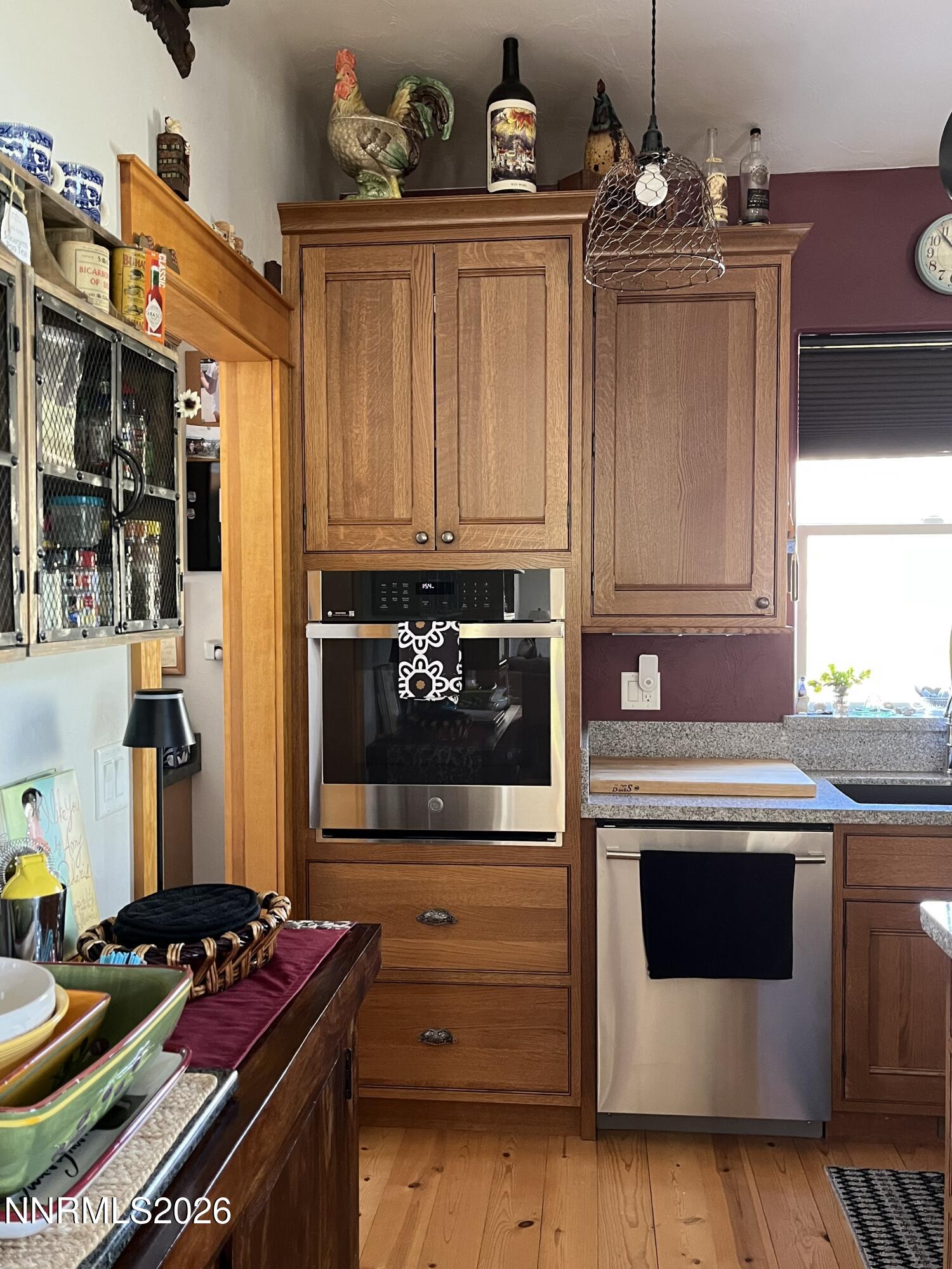 15 Wine Glass Way Kingston, NV 89310 - Photo 21 of 59 a kitchen with stainless steel appliances a stove a microwave and cabinets