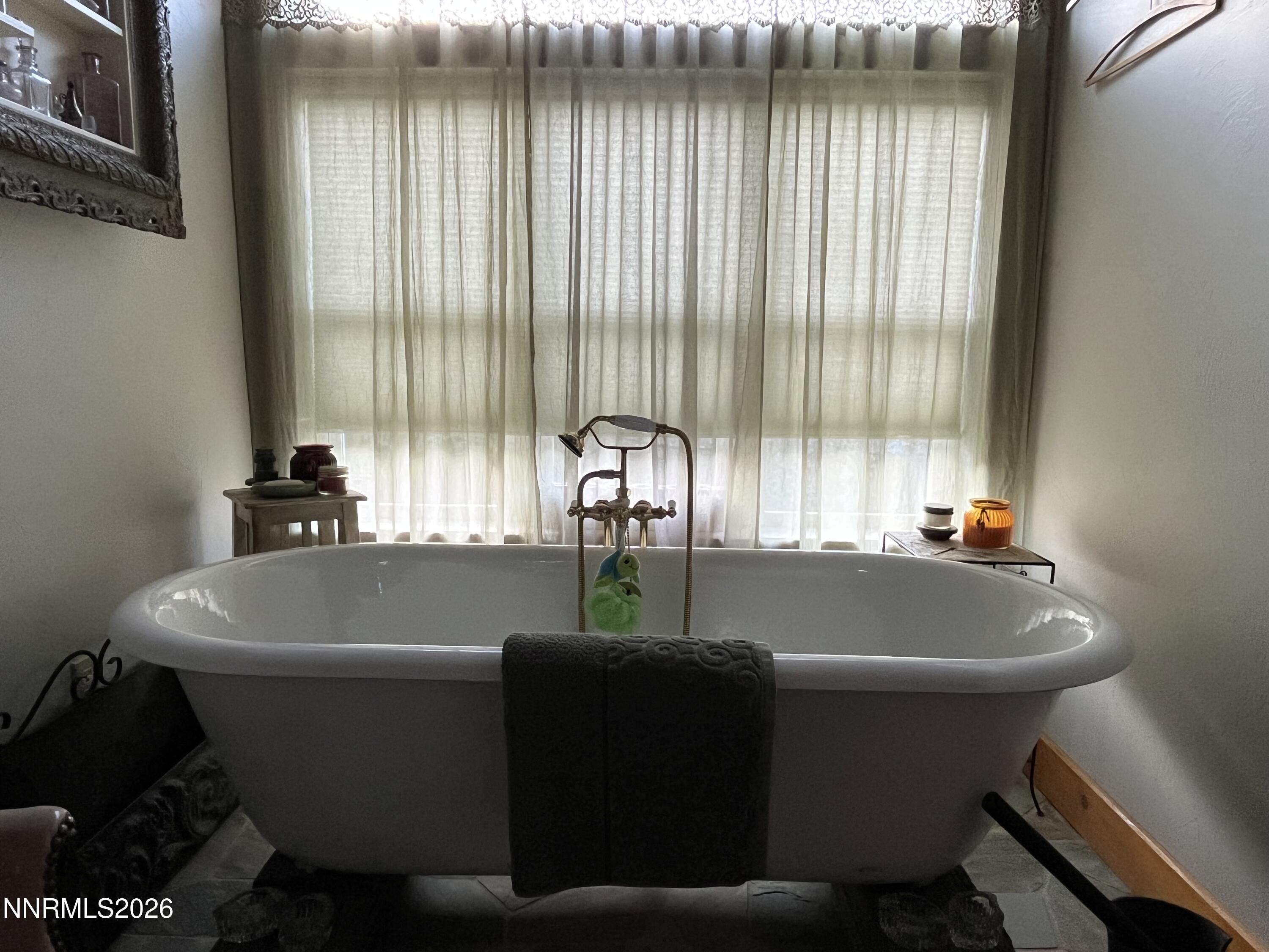 15 Wine Glass Way Kingston, NV 89310 - Photo 31 of 59 a white bath tub sitting in a bathroom next to a window