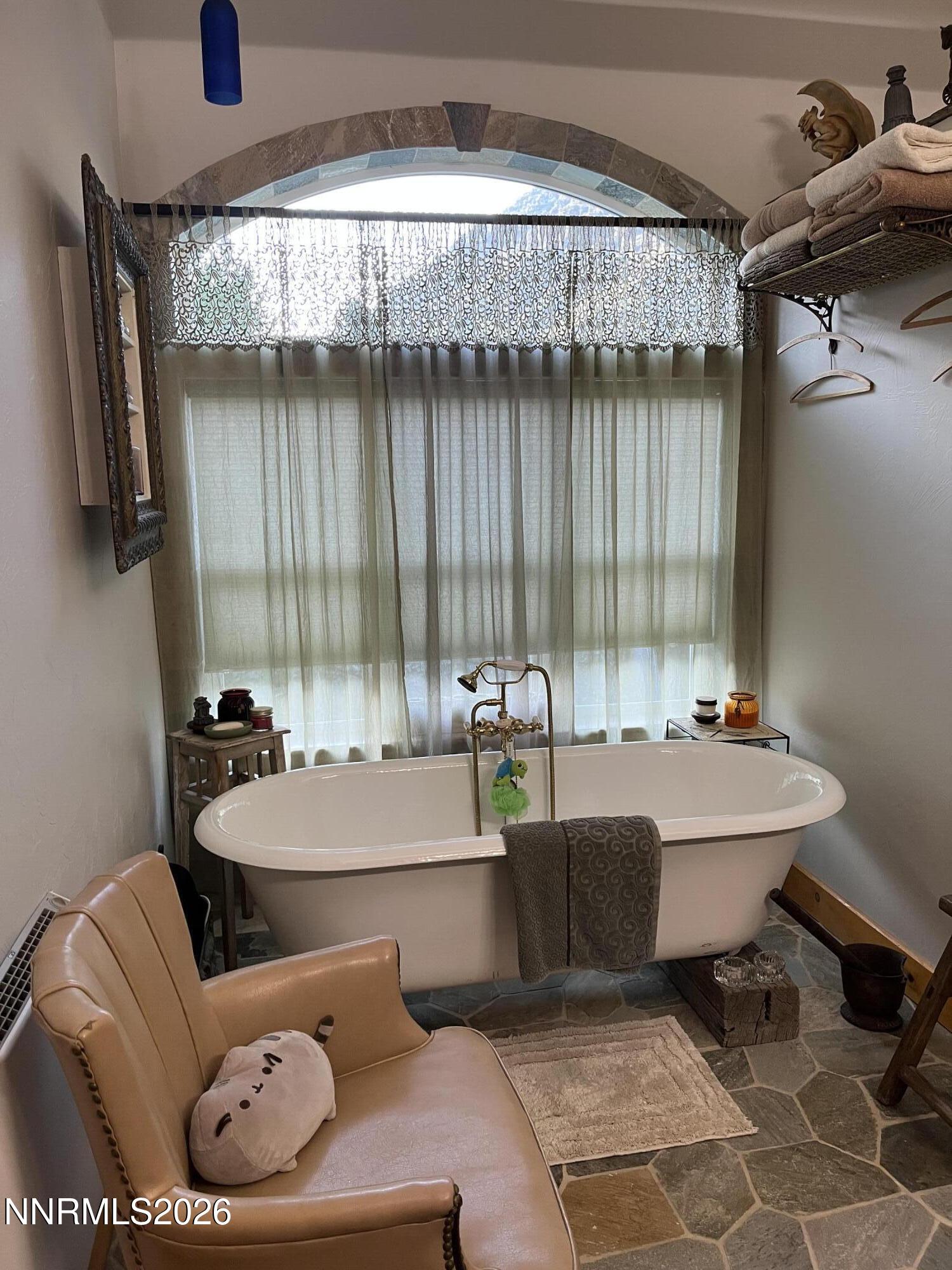15 Wine Glass Way Kingston, NV 89310 - Photo 32 of 59 a room with a bed and a chandelier
