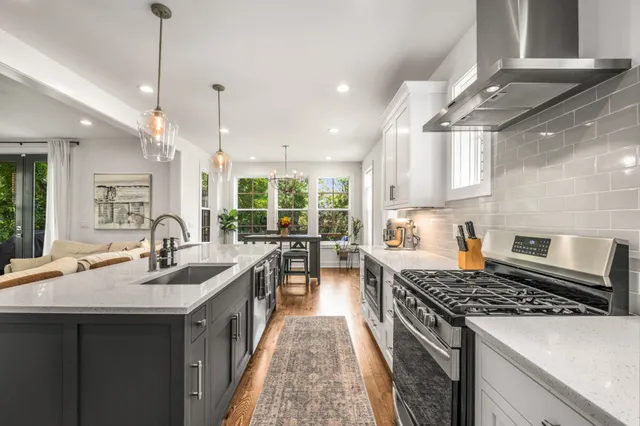 a kitchen with sink stove and cabinets