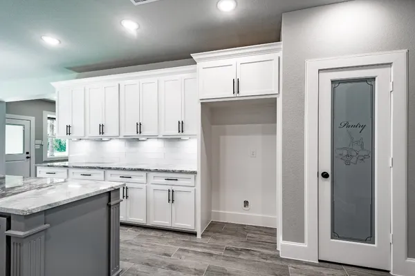 a kitchen with stainless steel appliances granite countertop a sink and cabinets