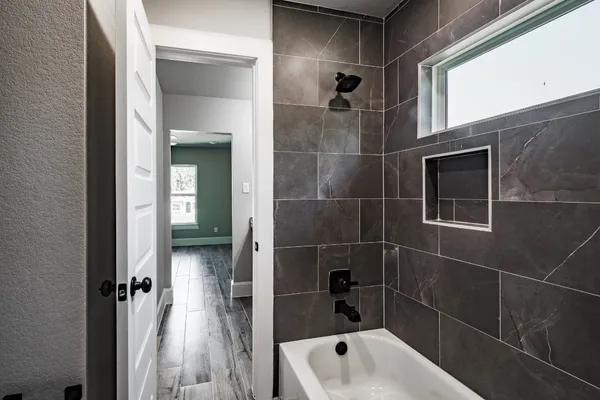 a bathroom with a bathtub and a shower