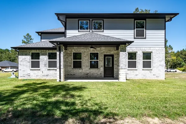a house that has a big yard with wooden fence