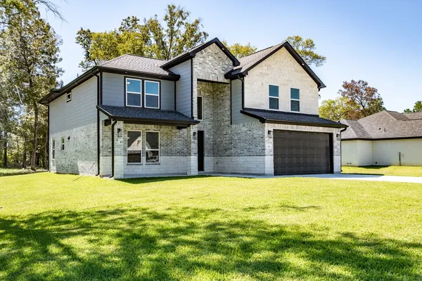 a view of a house with pool and a yard