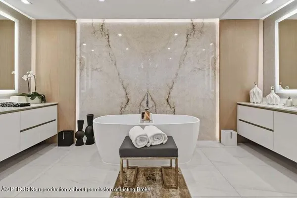 a kitchen with kitchen island a stove a counter space and a sink