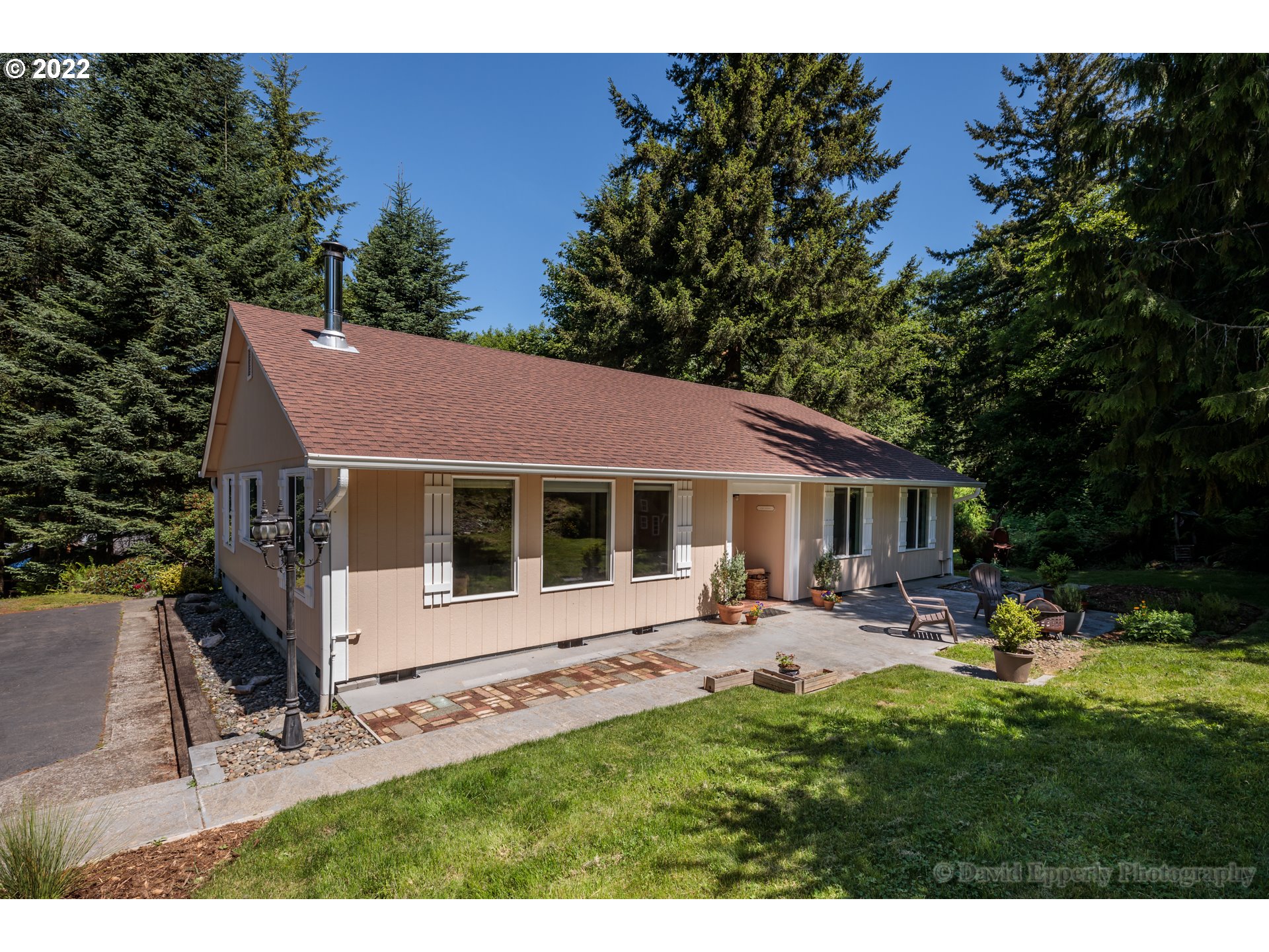 73722 Sold Road Rainier, OR 97048 - Photo 3 of 24 a view of a house with backyard sitting area and garden