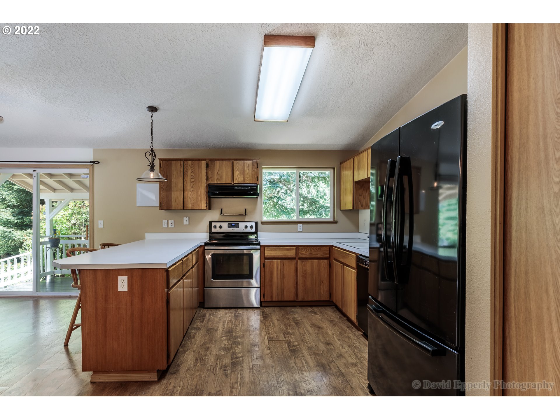 73722 Sold Road Rainier, OR 97048 - Photo 10 of 24 a kitchen with stainless steel appliances granite countertop a stove a refrigerator and a wooden floors