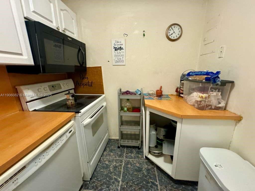 3730 Inverrary Drive, Unit 3B Lauderhill, FL 33319 - Photo 32 of 53 a kitchen with a stove and a microwave