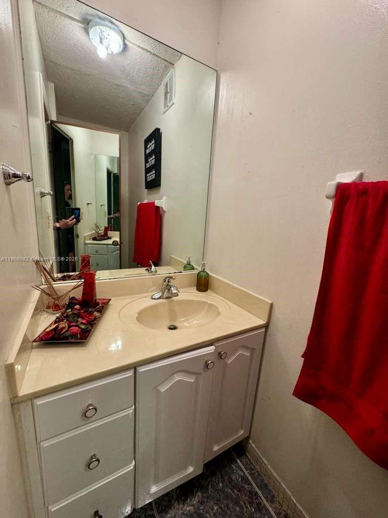 3730 Inverrary Drive, Unit 3B Lauderhill, FL 33319 - Photo 33 of 53 a bathroom with a sink and a mirror