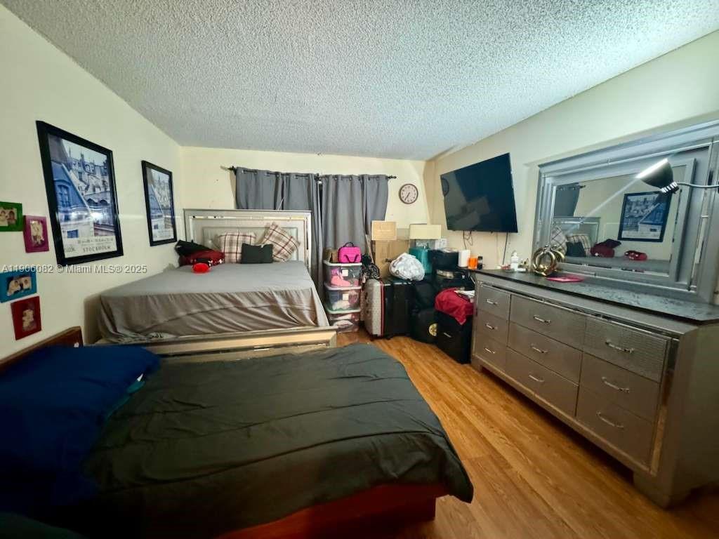 3730 Inverrary Drive, Unit 3B Lauderhill, FL 33319 - Photo 37 of 53 a bedroom with a bed and a flat screen tv