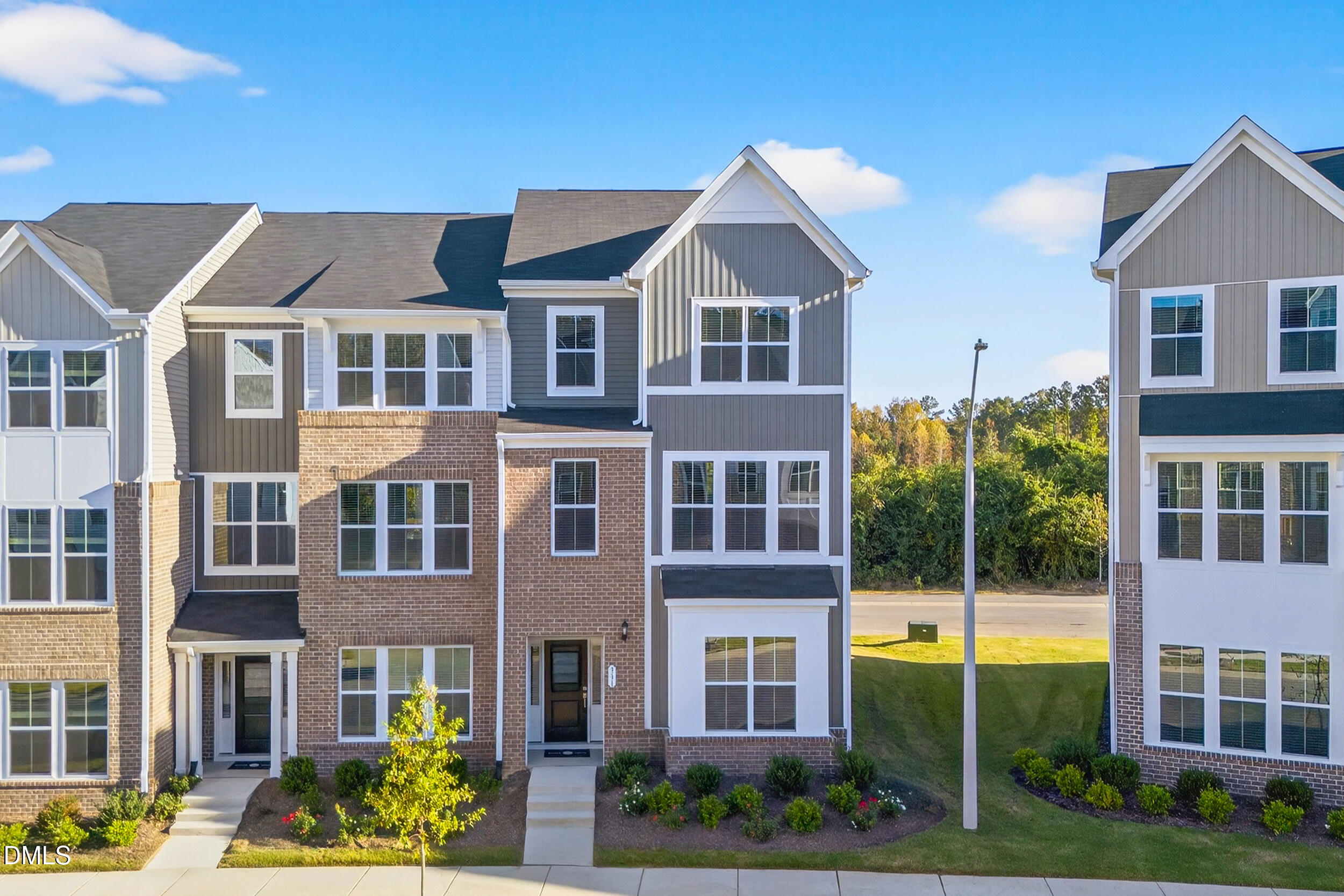 331 Chesapeake Commons Street Garner, NC 27529 - Photo 2 of 20 a view of a brick building next to a yard