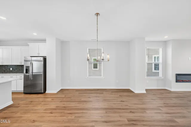 a view of a kitchen with a sink refrigerator and window