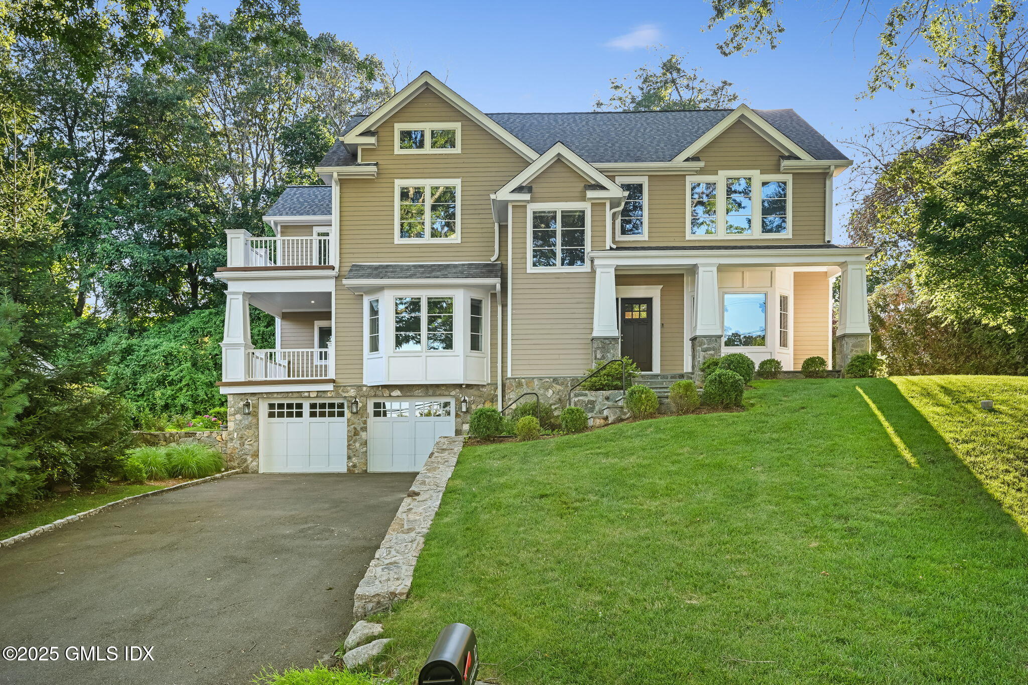 12 Old Wagon Road Old Greenwich, CT 06870 - Photo 1 of 57 a front view of a house with a yard