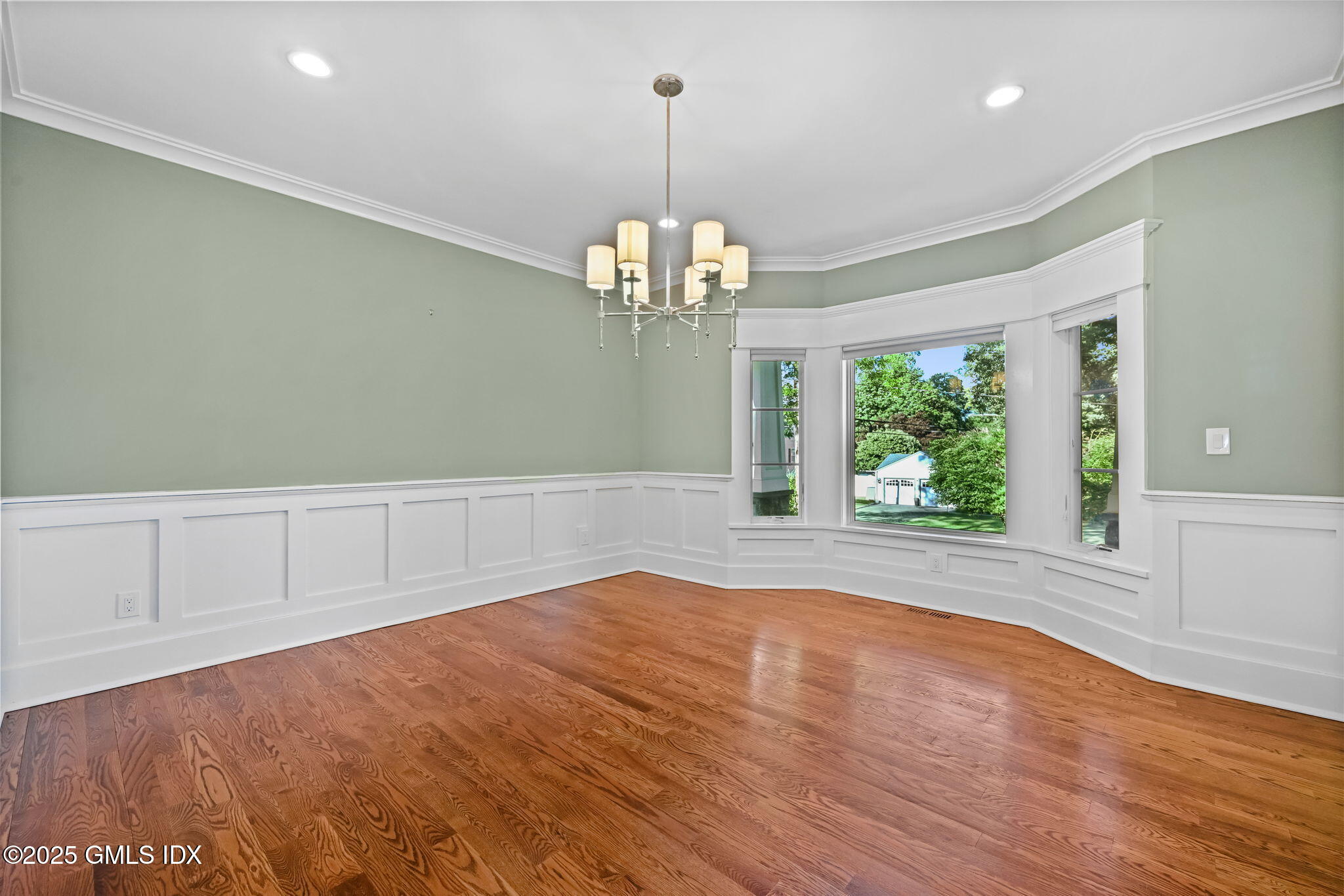 12 Old Wagon Road Old Greenwich, CT 06870 - Photo 17 of 57 an empty room with wooden floor and windows
