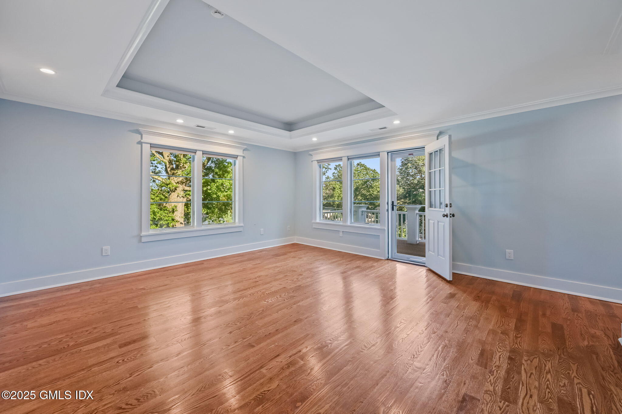 12 Old Wagon Road Old Greenwich, CT 06870 - Photo 32 of 57 an empty room with wooden floor and natural light