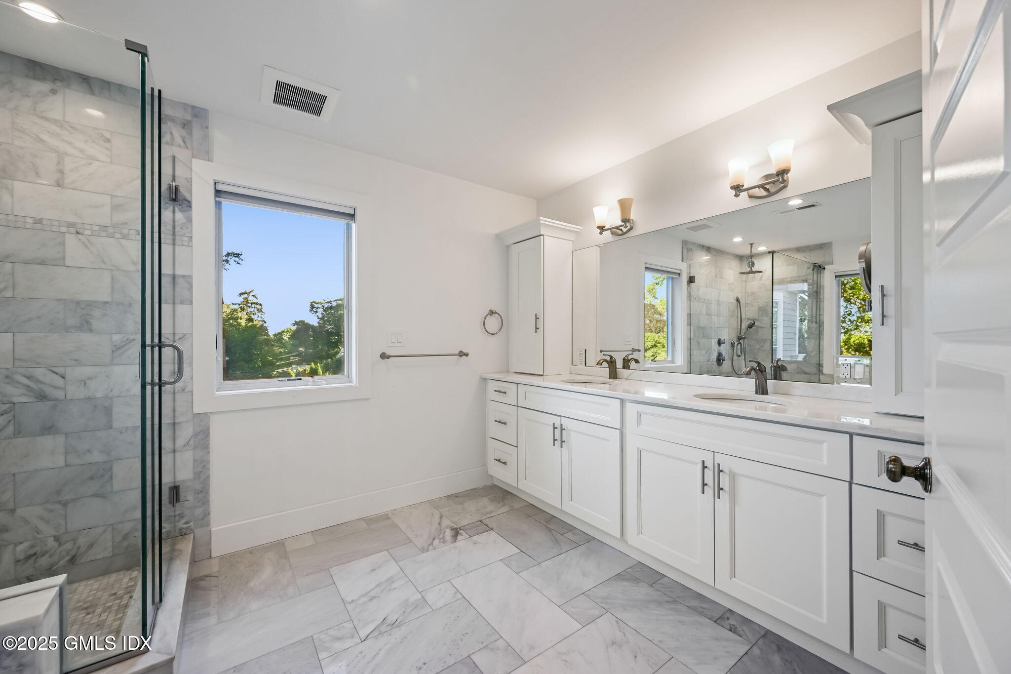 12 Old Wagon Road Old Greenwich, CT 06870 - Photo 38 of 57 a spacious bathroom with a granite countertop sink a mirror and a shower