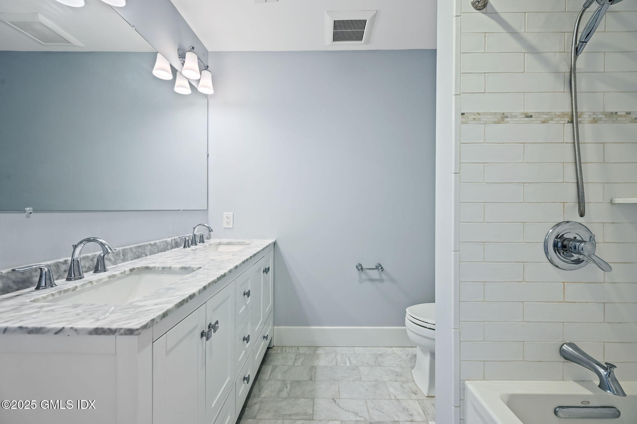 12 Old Wagon Road Old Greenwich, CT 06870 - Photo 44 of 57 a bathroom with a granite countertop sink a toilet and shower