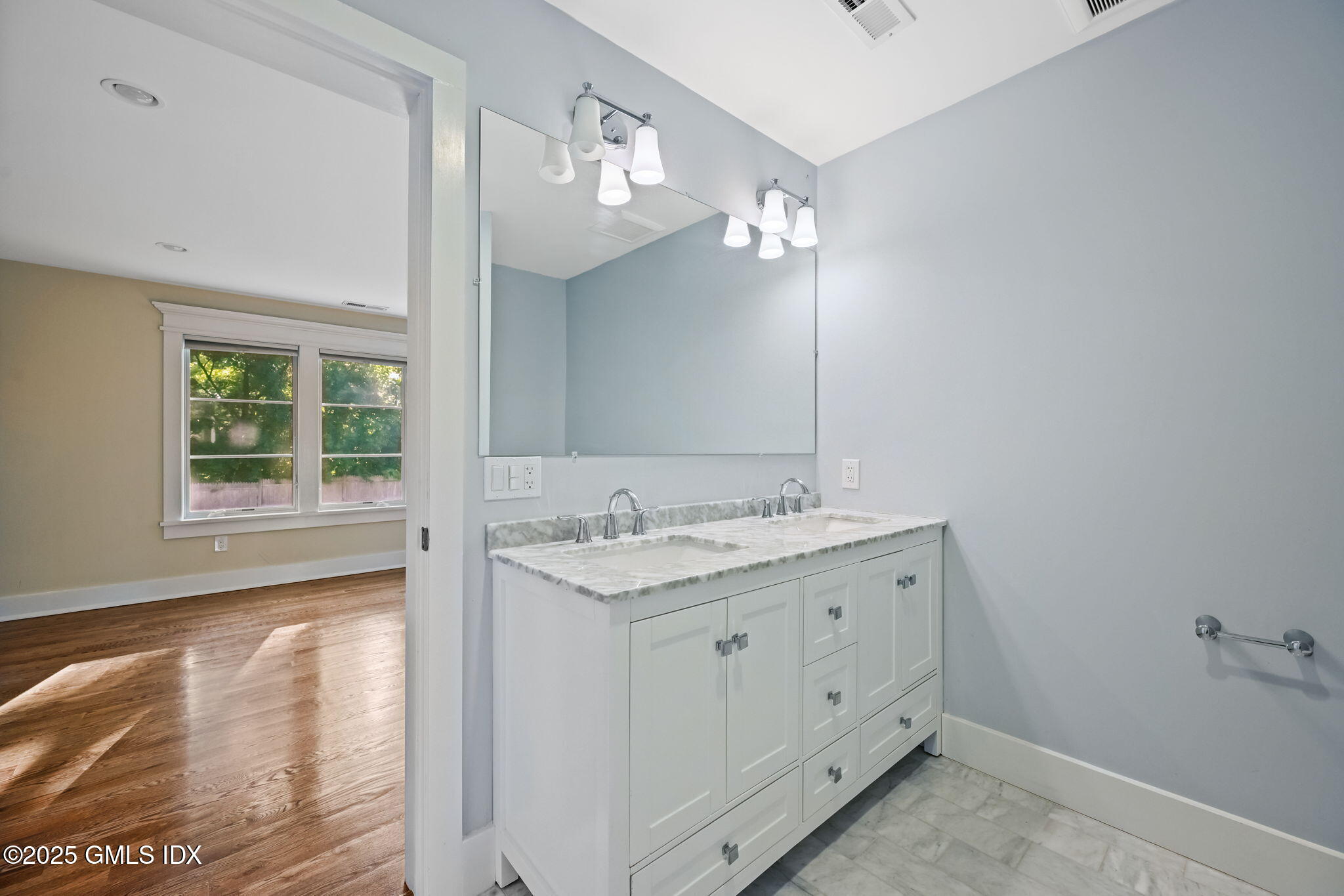 12 Old Wagon Road Old Greenwich, CT 06870 - Photo 45 of 57 a bathroom with a granite countertop sink a large mirror and a shower